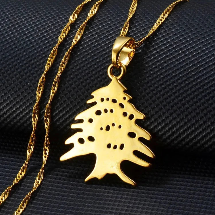 Gold cedar tree pendant necklace, inspired by the Lebanese national symbol, representing strength and heritage with an elegant and refined design.